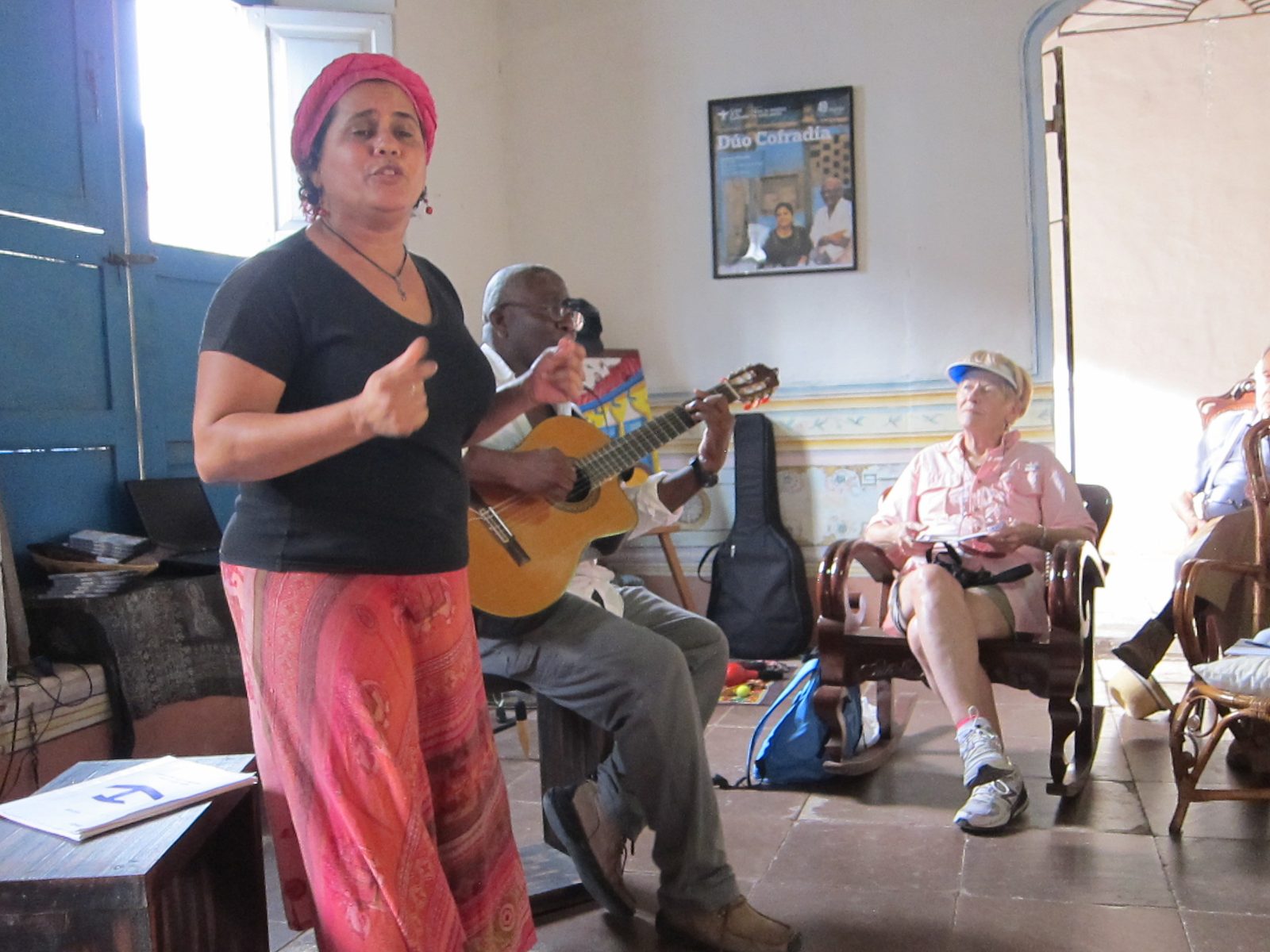 She sings (and talks non-stop) while her husband plays guitar and sings.